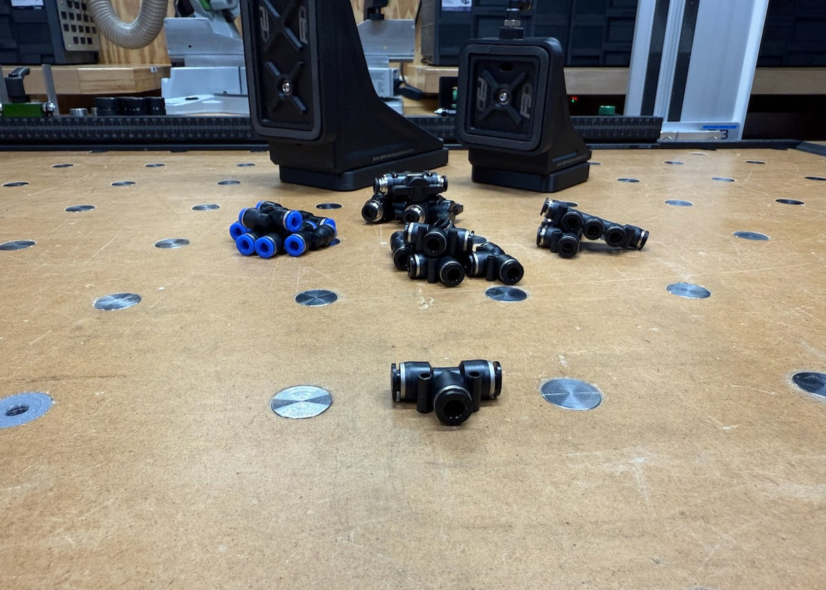 Push to connect fittings, tubing, and ball valve laid out on the bench.